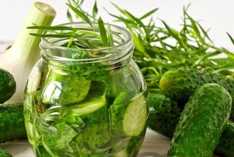 tarragon and cucumbers in a jar on the table