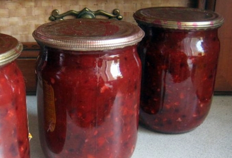 plum adjika in jars on the table