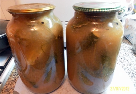 cucumbers in apple juice in jars