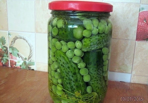 cucumbers with green peas in a jar