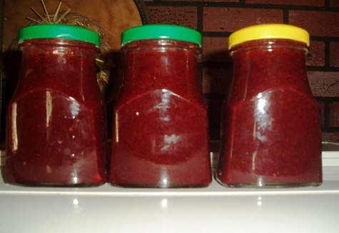 red currant sauce in jars on the table