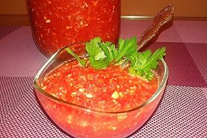 Recetas para adzhika cruda de tomate y ajo sin cocinar para el invierno.