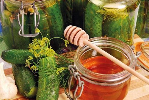 cucumbers with honey in jars on the table