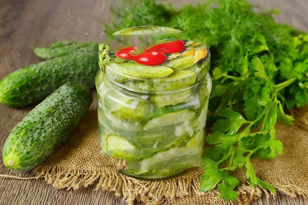 cucumbers with herbs in a jar