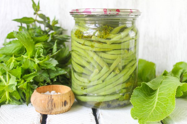 asparagus beans with herbs in a jar